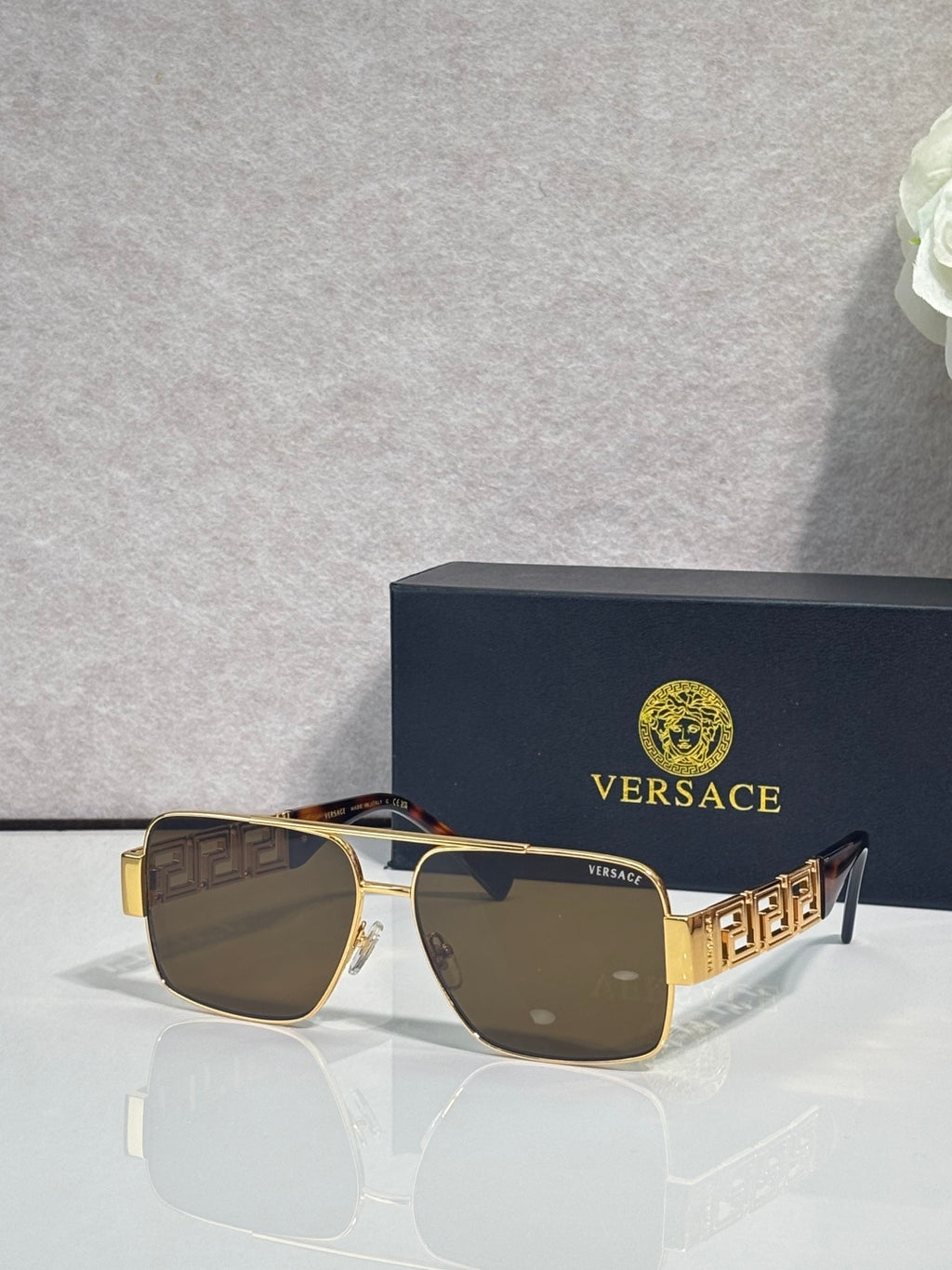 Versace sunglasses with gold frame and brown lenses, Greek-key temple accents