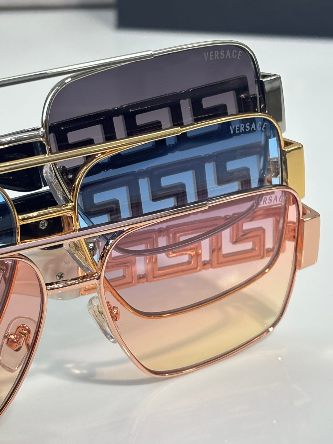 Versace sunglasses close-up of temples with Greek-key pattern and tinted lens