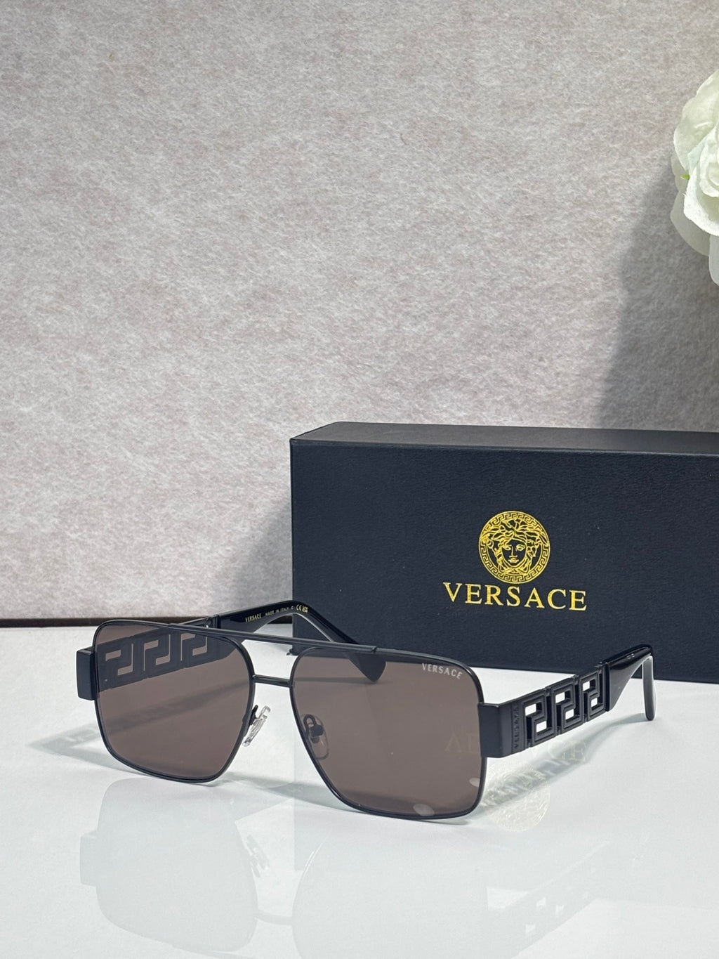 Versace sunglasses with silver frame and dark brown lenses, navy geometric temples