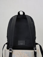 YSL black backpack back view with adjustable shoulder straps and logo patch