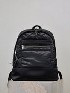 YSL black nylon backpack with front zip pockets and drawstring pull tabs