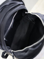 YSL black backpack interior view with fabric lining and side zipper opening