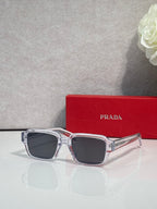 Silver square sunglasses with dark lenses and clear temple tips
