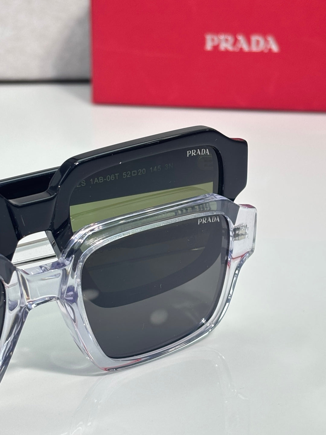 Black square sunglasses with dark lens and clear frame edge
