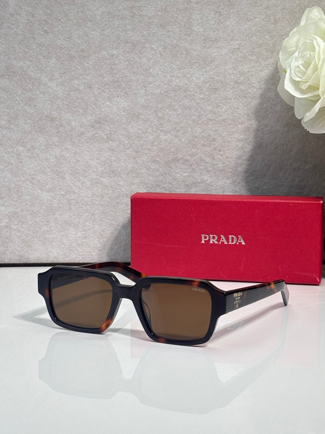 Dark brown square sunglasses with gradient lenses and white side arms