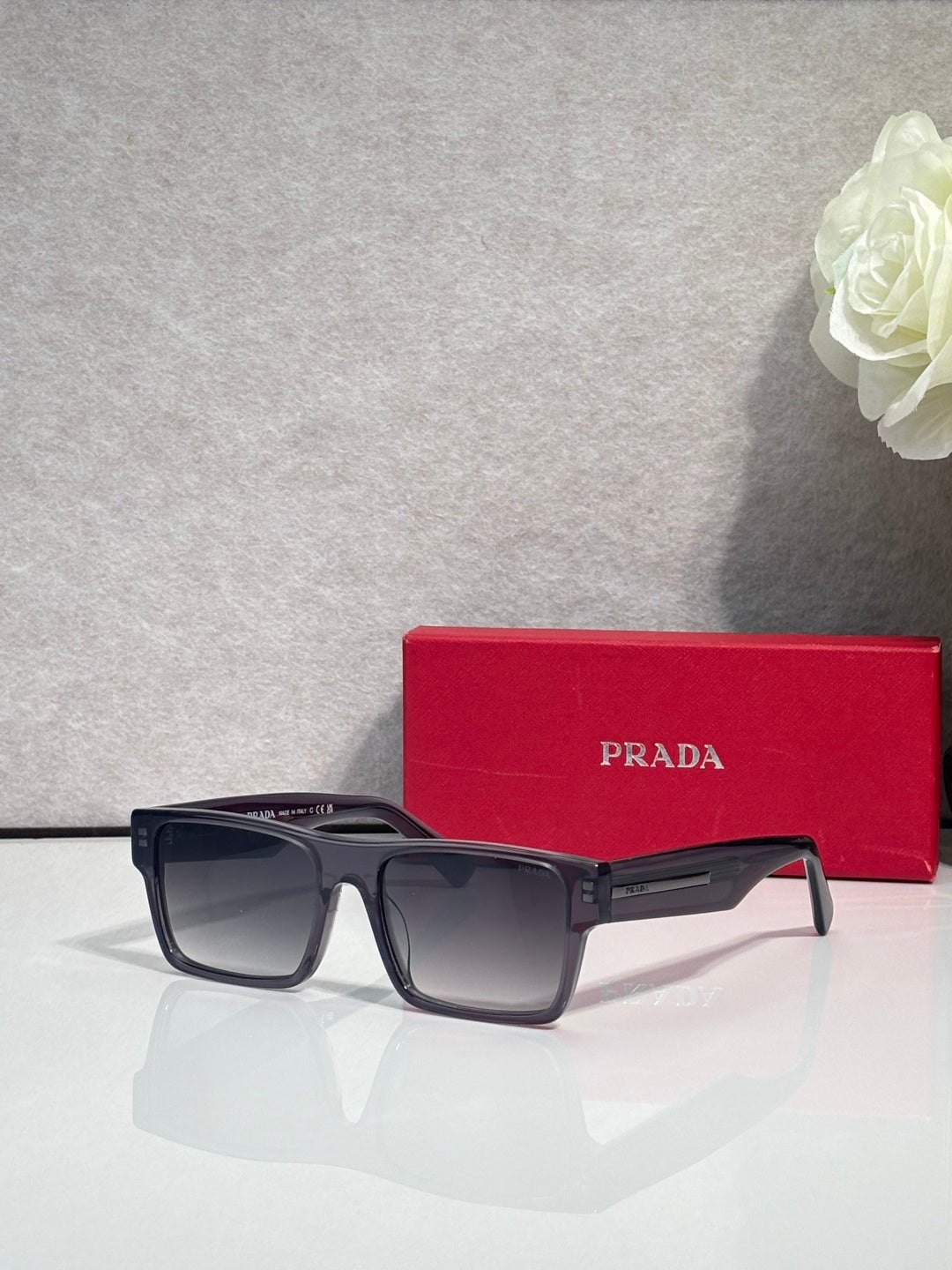 Prada square sunglasses with dark frames and dark smoke lenses