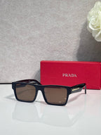 Prada square sunglasses with dark frames and amber-brown gradient lenses