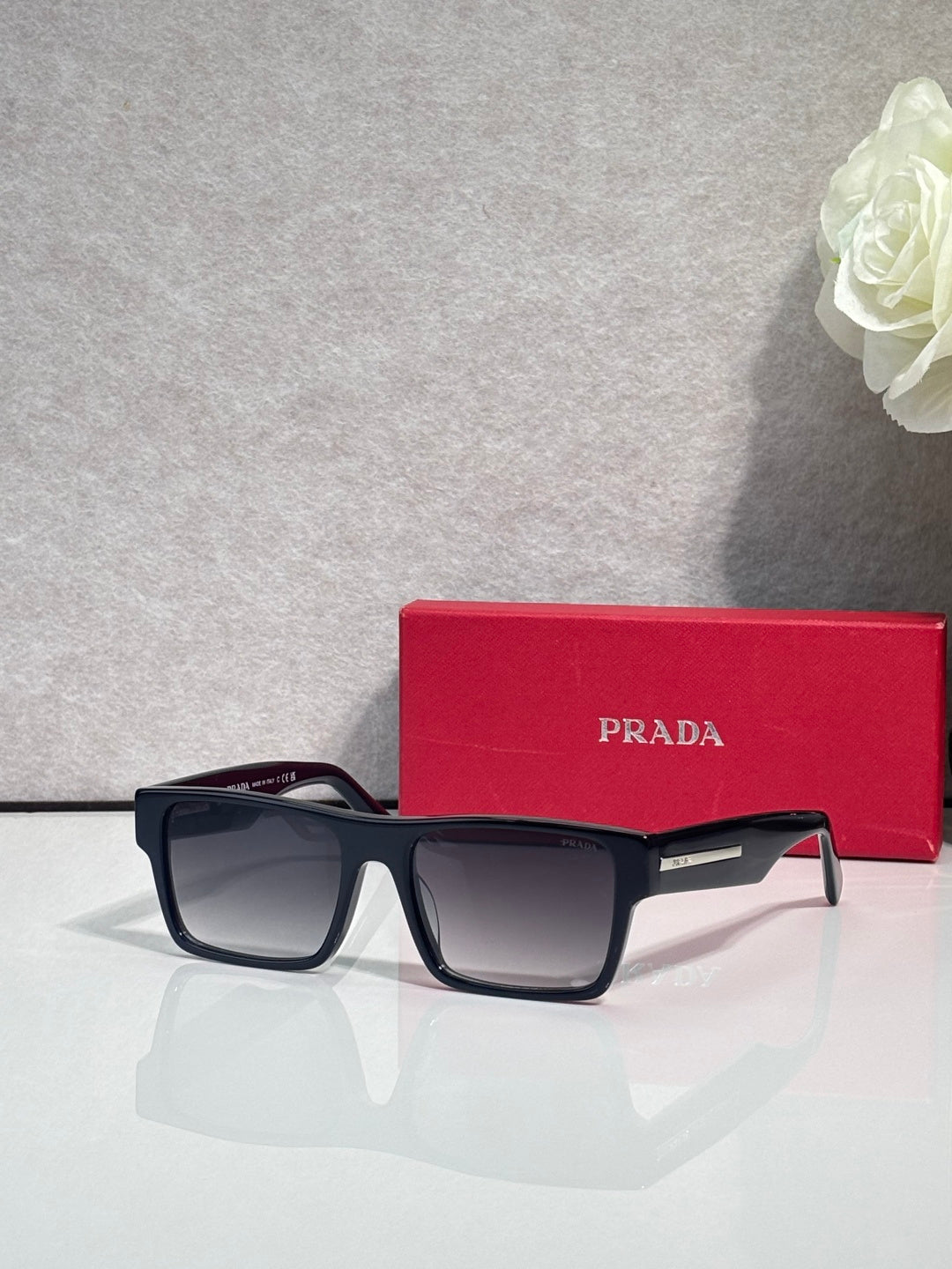Prada square sunglasses with dark frames and gray tinted lenses