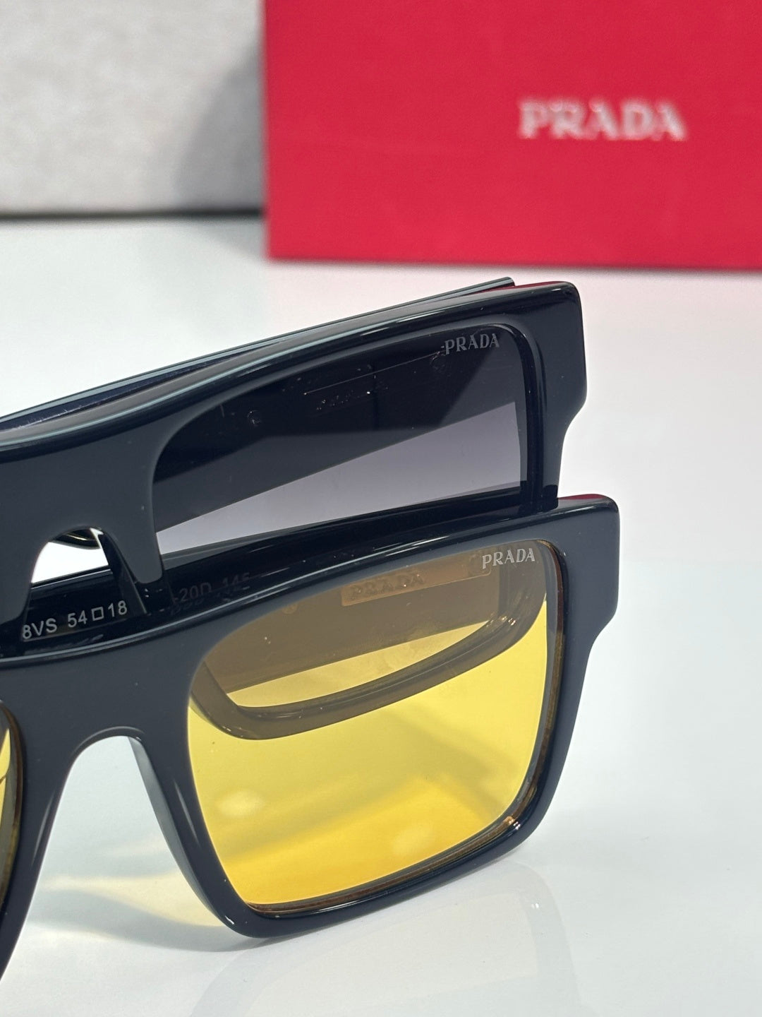 Prada sunglasses close-up of dark frame and yellow mirror lenses