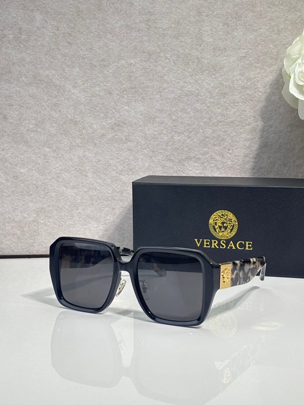 Versace square sunglasses with dark blue frame and smoky lenses, gold logo on hinge