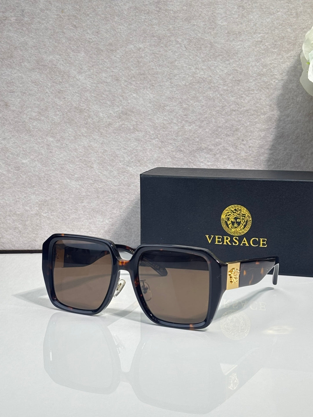 Versace square sunglasses with black frame and brown gradient lenses, gold logo