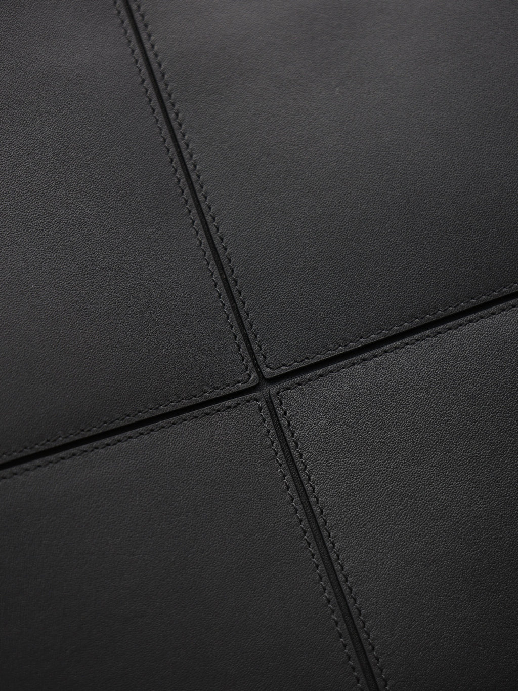 YSL black leather-look tote bag close-up of stitched seam panel