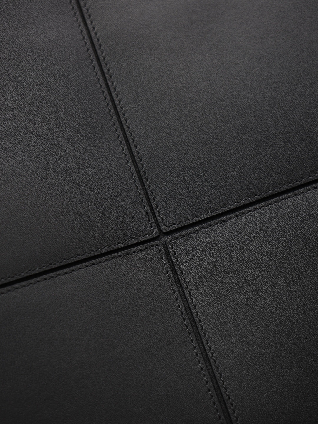 YSL black leather-look tote bag close-up of stitched seam panel