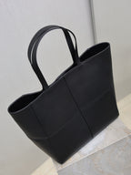 YSL black tote bag with top handles, open-top silhouette and stitched panels