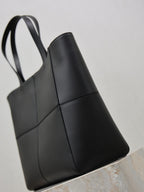 YSL black tote bag with top handles and curved seam details