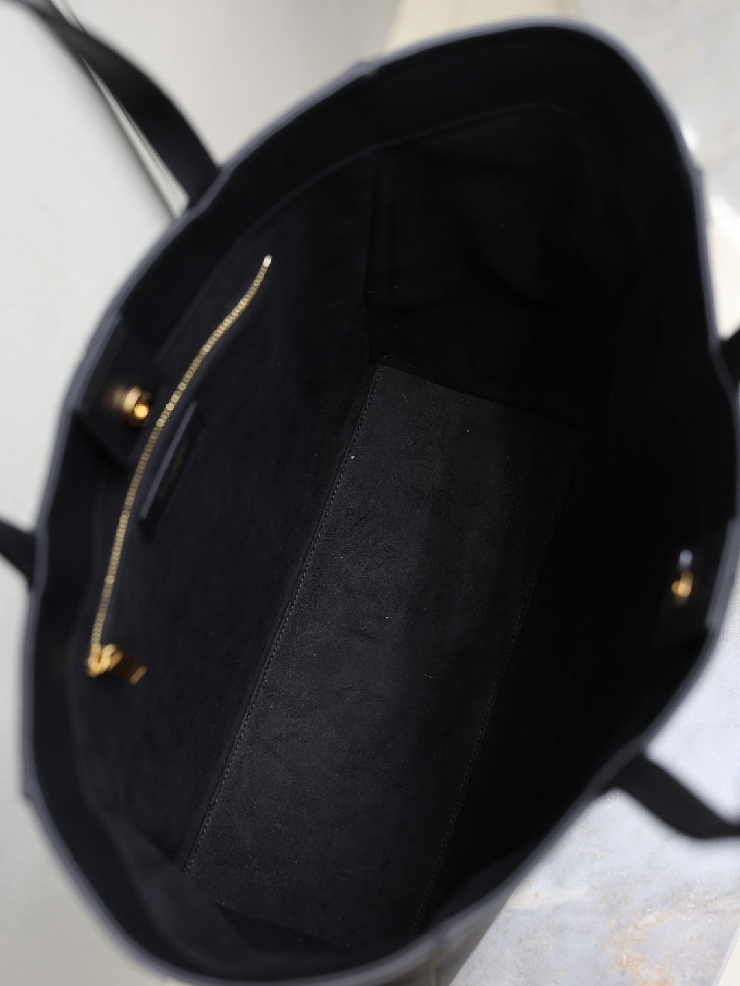 YSL black tote bag interior with zip pocket and gold-tone hardware