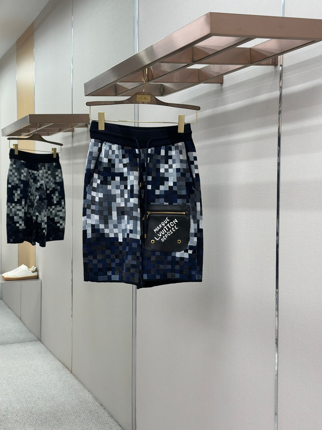 Louis Vuitton checkered shorts in blue and white pixel pattern, elastic waistband