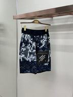 Blue and white pixel-check shorts with black waistband and drawcord
