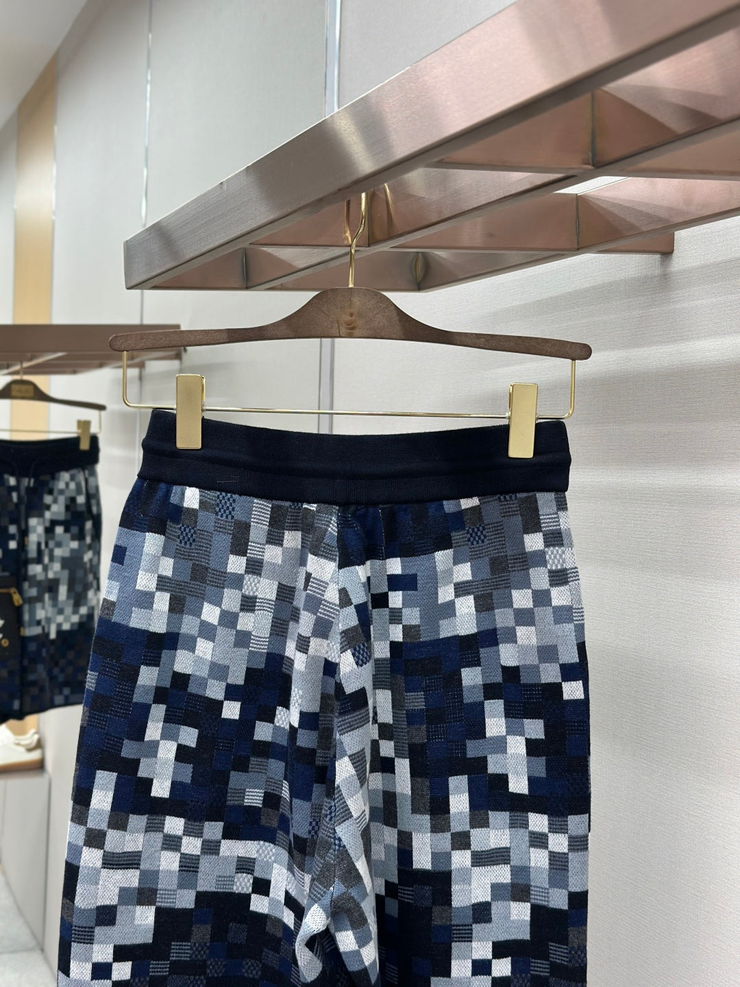Blue and white pixel-check shorts with elastic waistband and drawcord
