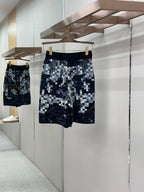 Checkered shorts in blue with white pixel pattern, elastic waistband and drawcord