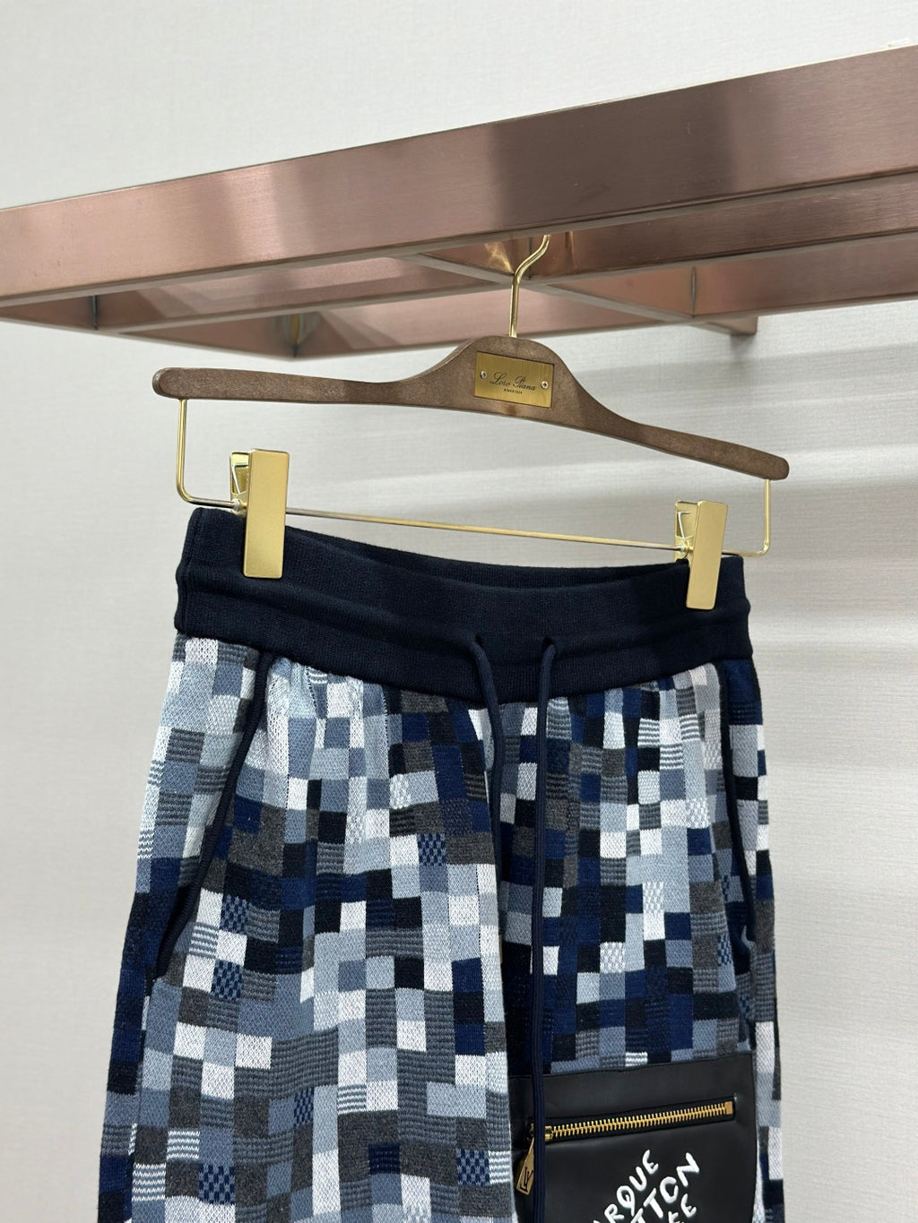 Navy and blue pixel-check shorts with side pouch, gold zipper and snap buttons