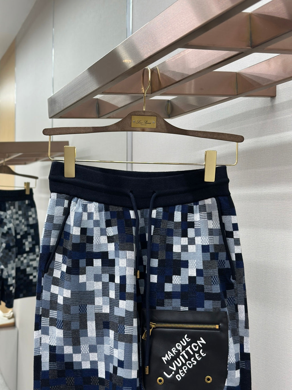 Pixel-check shorts with black waistband and side black pouch with gold zipper