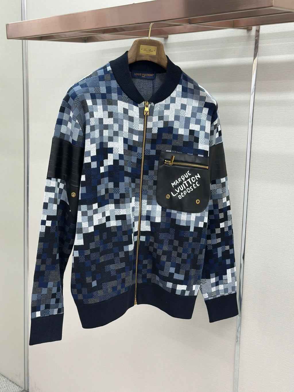 Zip-up jacket with blue/white check knit, black chest pocket, gold zipper