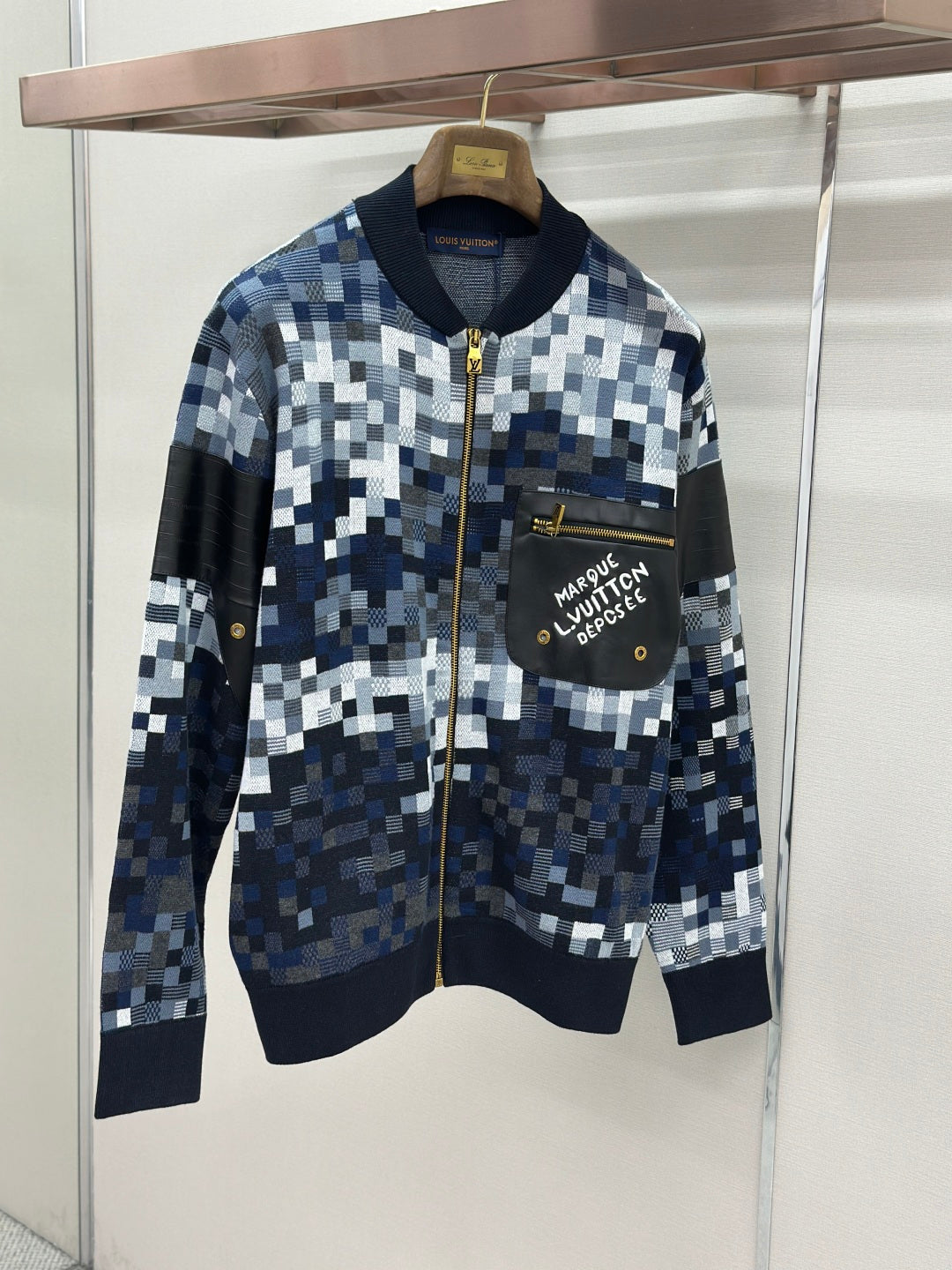 Zip-up jacket with blue/white check knit, black chest pocket, gold zipper