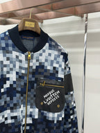 Zip-up jacket upper front, black chest pocket with Louis Vuitton text, gold zipper