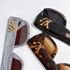 Louis Vuitton glasses close-up with translucent gray and black frames, tinted lenses