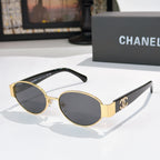 Gold-rim round sunglasses with dark lenses and black temples; Chanel logo on arms.
