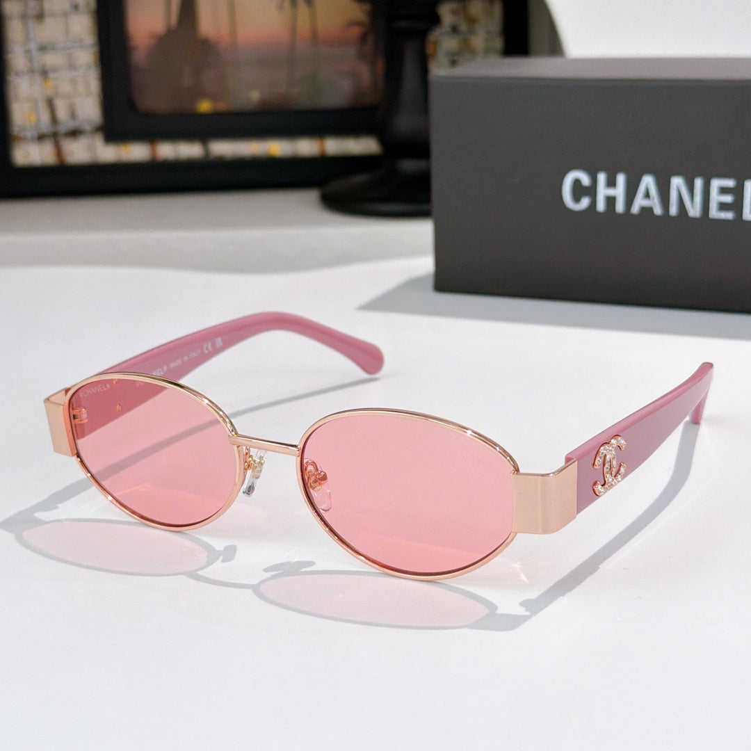 Pink round sunglasses with rose lenses and gold accents; Chanel logo on temple.