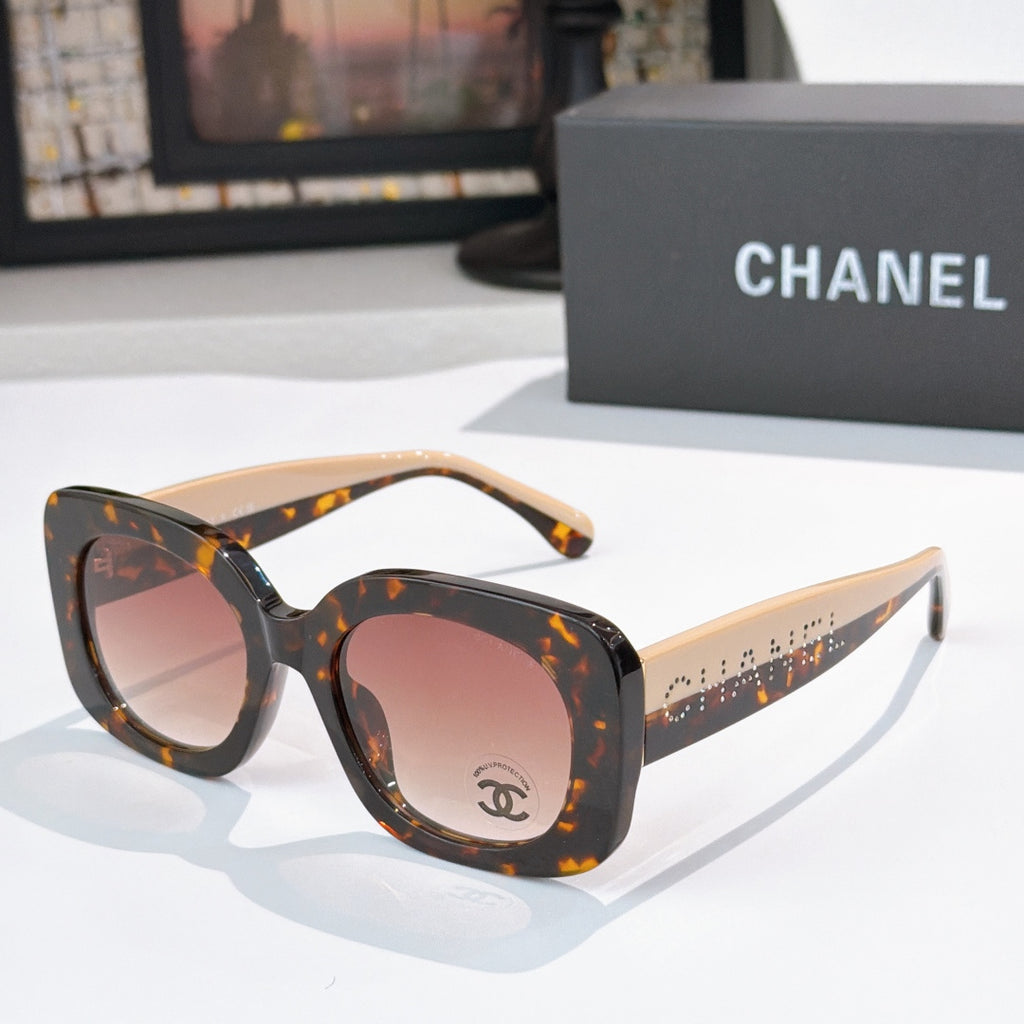 Chanel sunglasses with dark tortoise frame and pink tinted lenses, wide curved shape