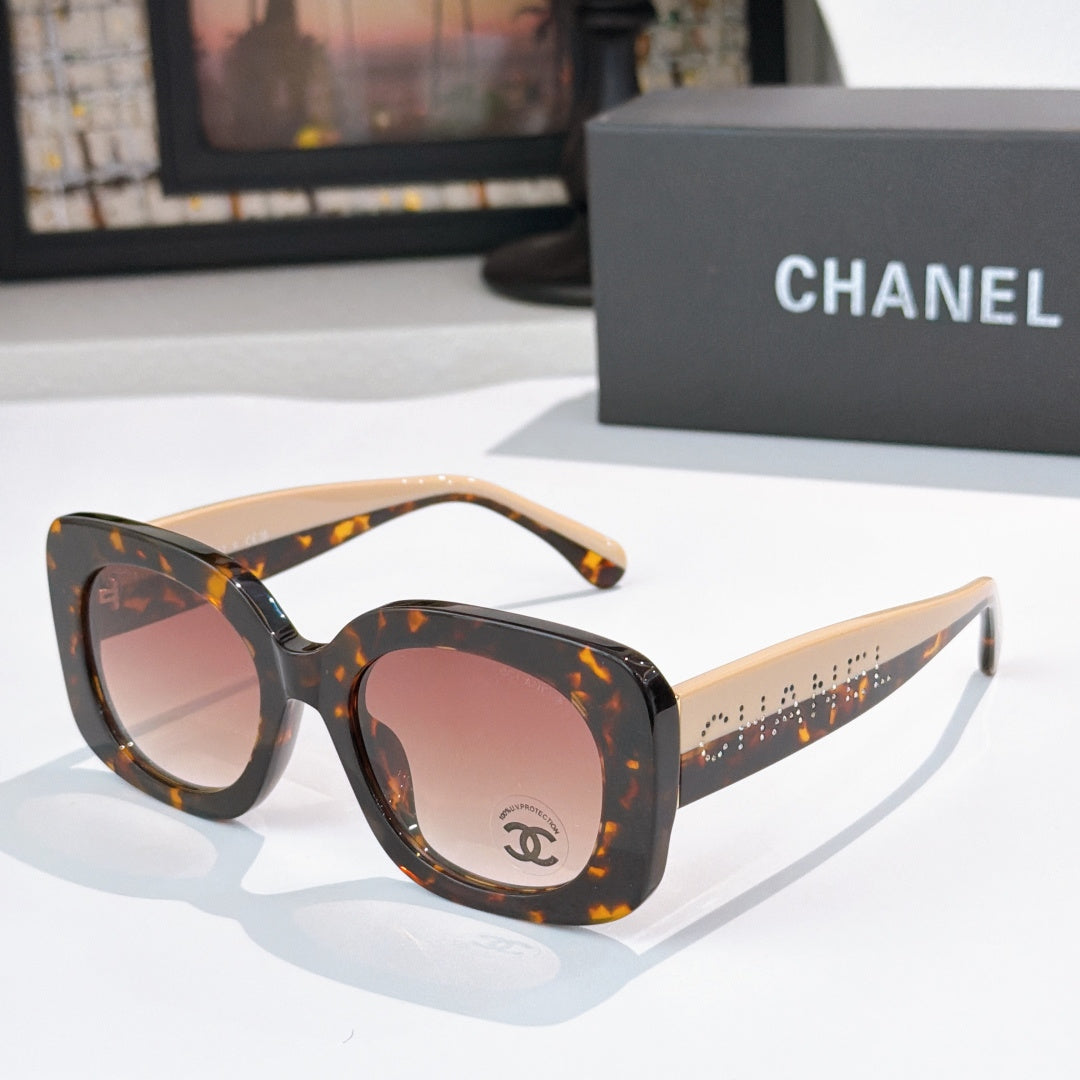 Chanel sunglasses with dark tortoise frame and pink tinted lenses, wide curved shape