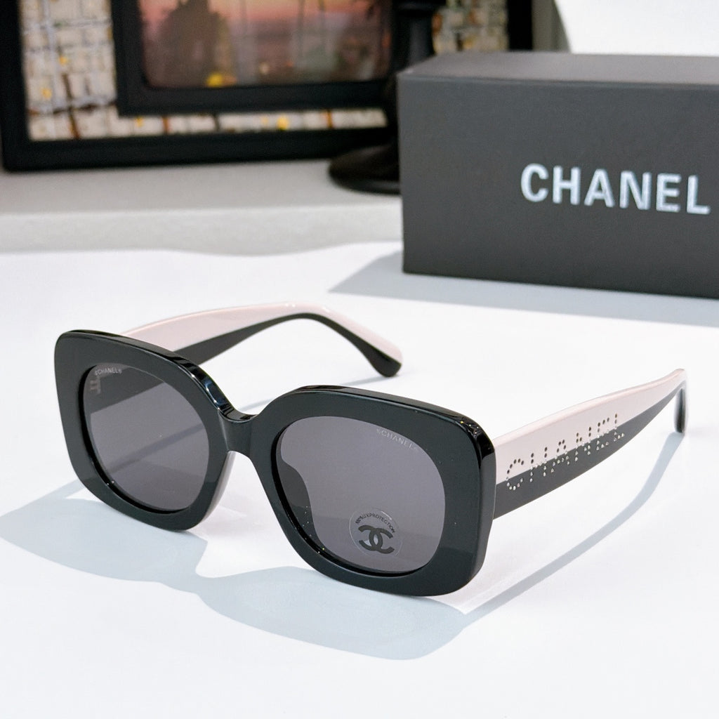 Chanel sunglasses with black frame and gray tinted lenses, beige-tan arms with dot pattern
