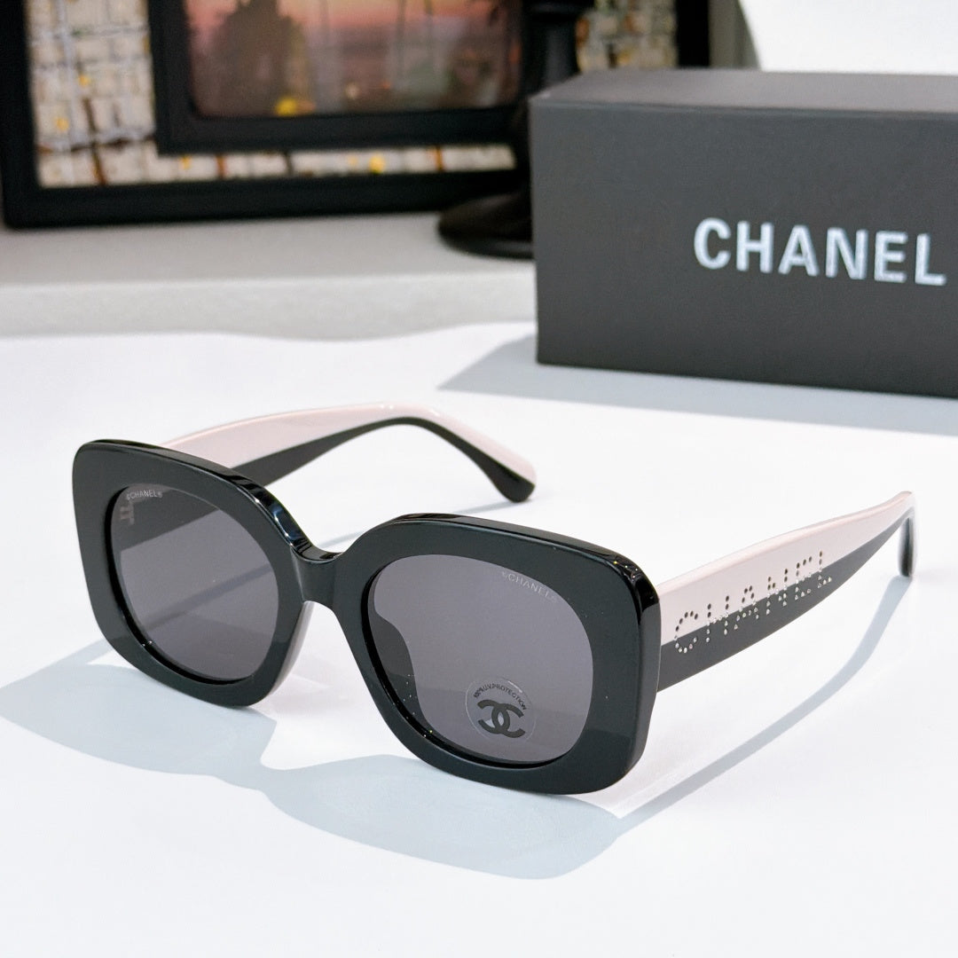 Chanel sunglasses with black frame and gray tinted lenses, beige-tan arms with dot pattern