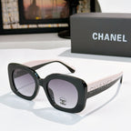 Chanel sunglasses with black frame and purple tinted lenses, angular oversized design