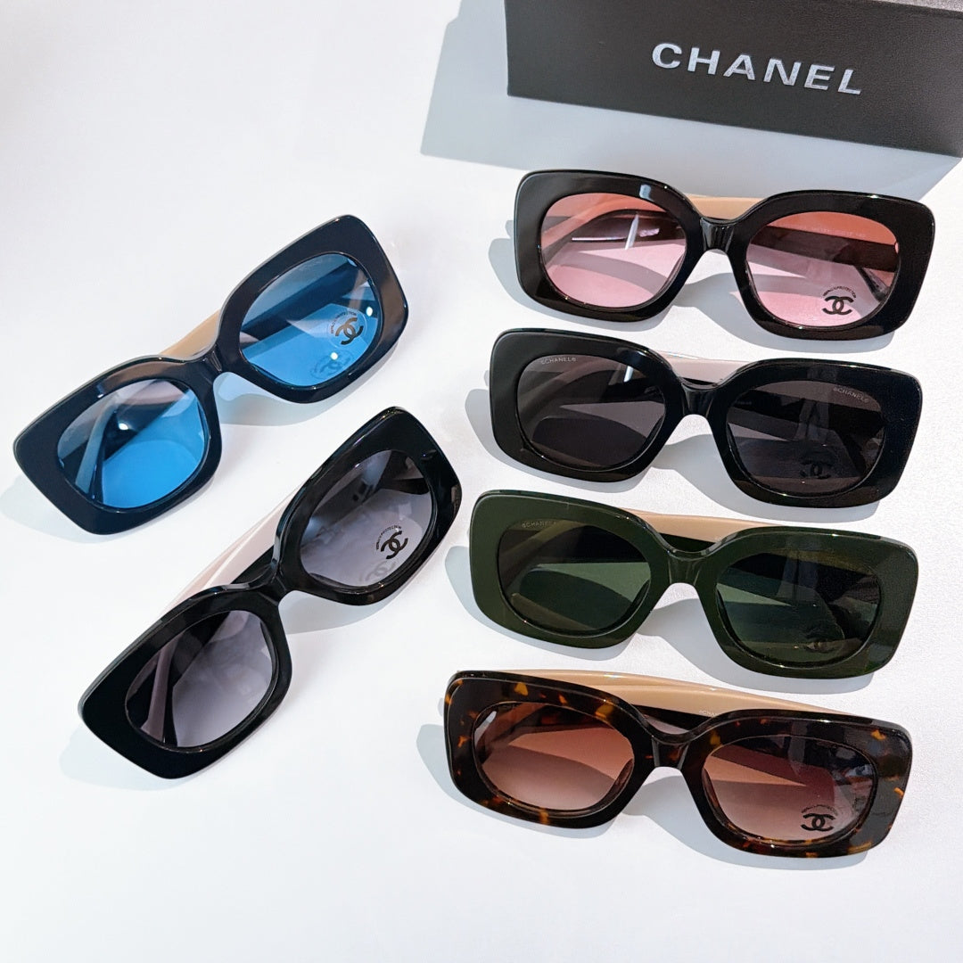Chanel sunglasses assortment laid out, featuring pink, blue, green, and tortoise lens colors