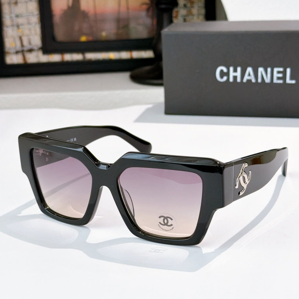 Square black sunglasses with purple tinted lenses and silver side logo