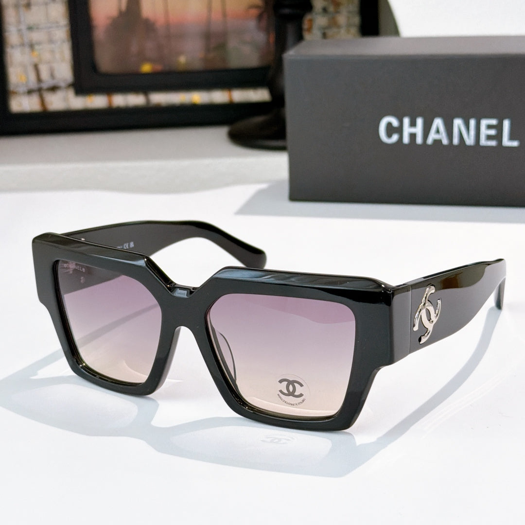 Square black sunglasses with purple tinted lenses and silver side logo