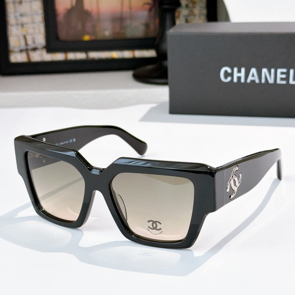 Square black sunglasses with beige tinted lenses and silver side logo