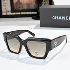Square black sunglasses with beige tinted lenses and silver side logo
