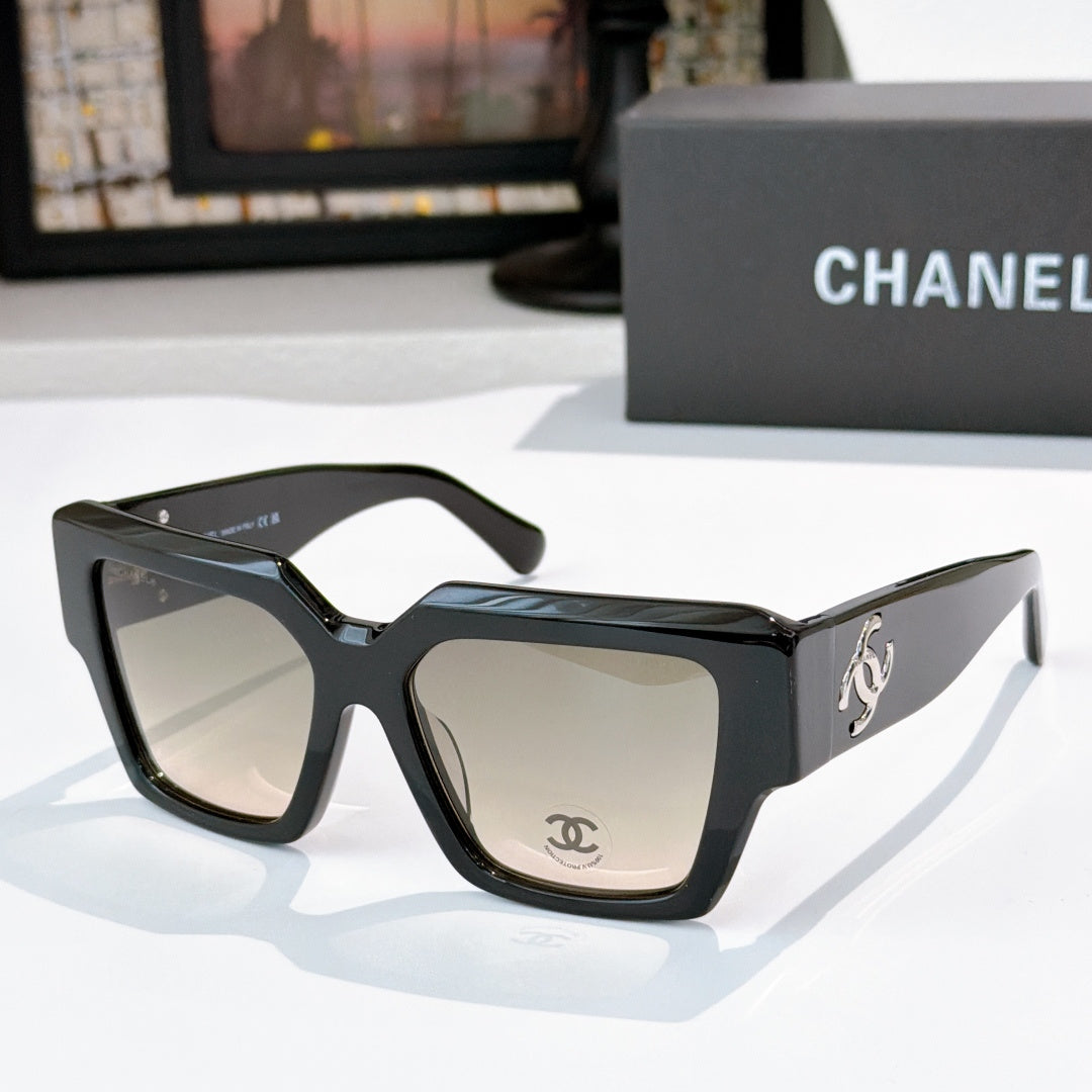 Square black sunglasses with beige tinted lenses and silver side logo