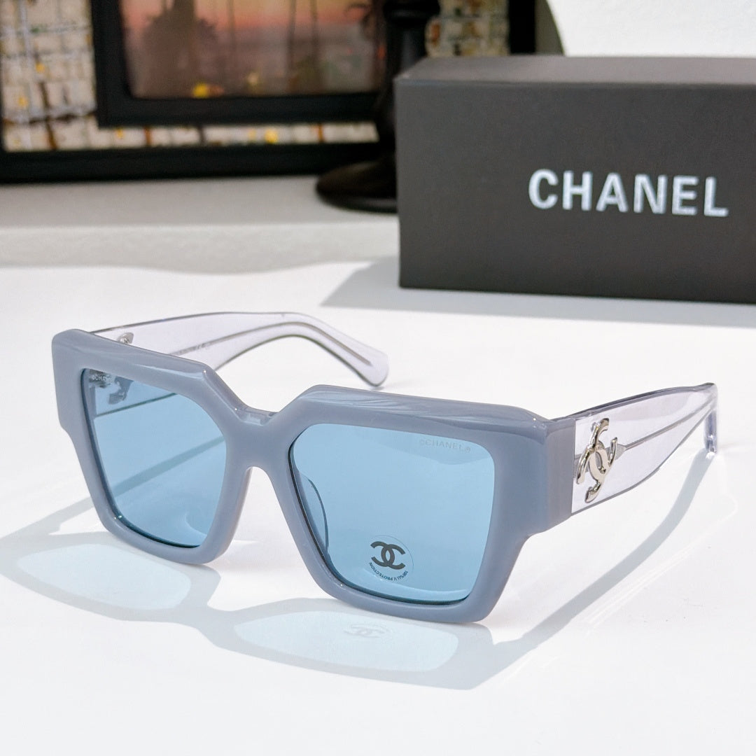 Square light blue sunglasses with blue tinted lenses and silver side logo