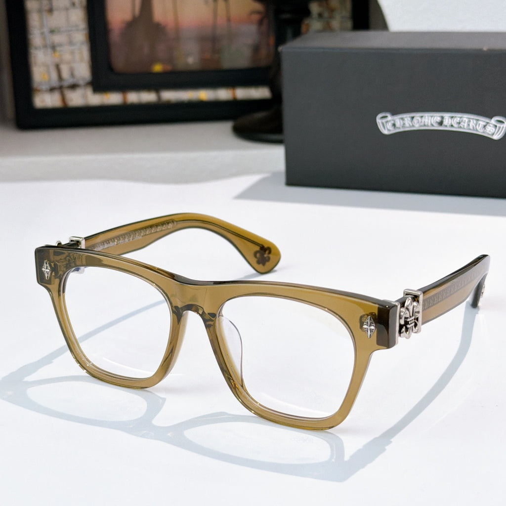 Gold-toned eyeglasses with white lenses and ornate gold-tone hinges.