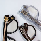 Assorted eyeglasses with decorative fleur-de-lis metal hinges and lens frames.