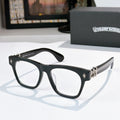 Black eyeglasses with gold-tone hinges and curved temple arms.