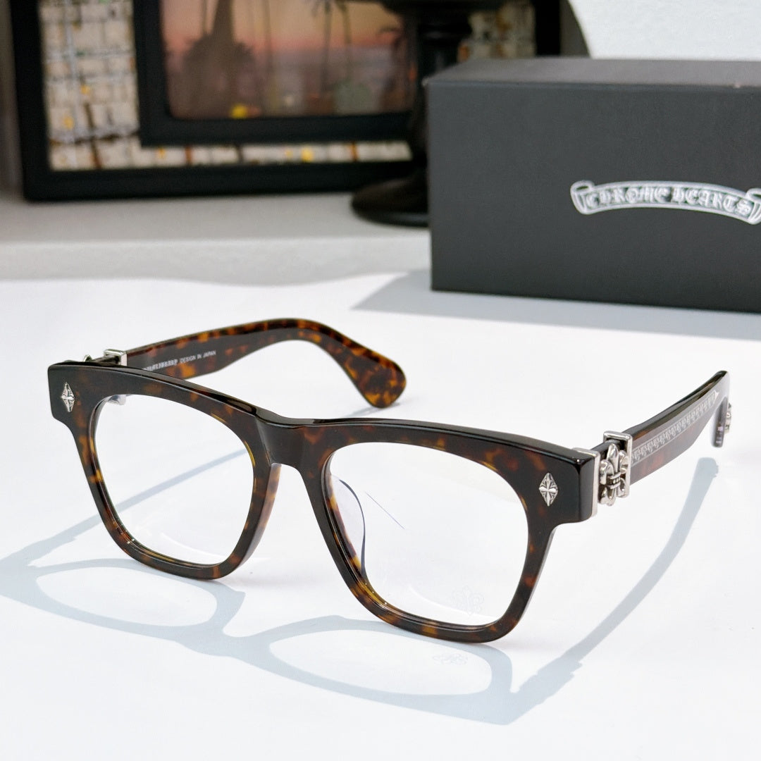 Tortoise brown eyeglasses with gold-tone hinges and decorative temple detail.