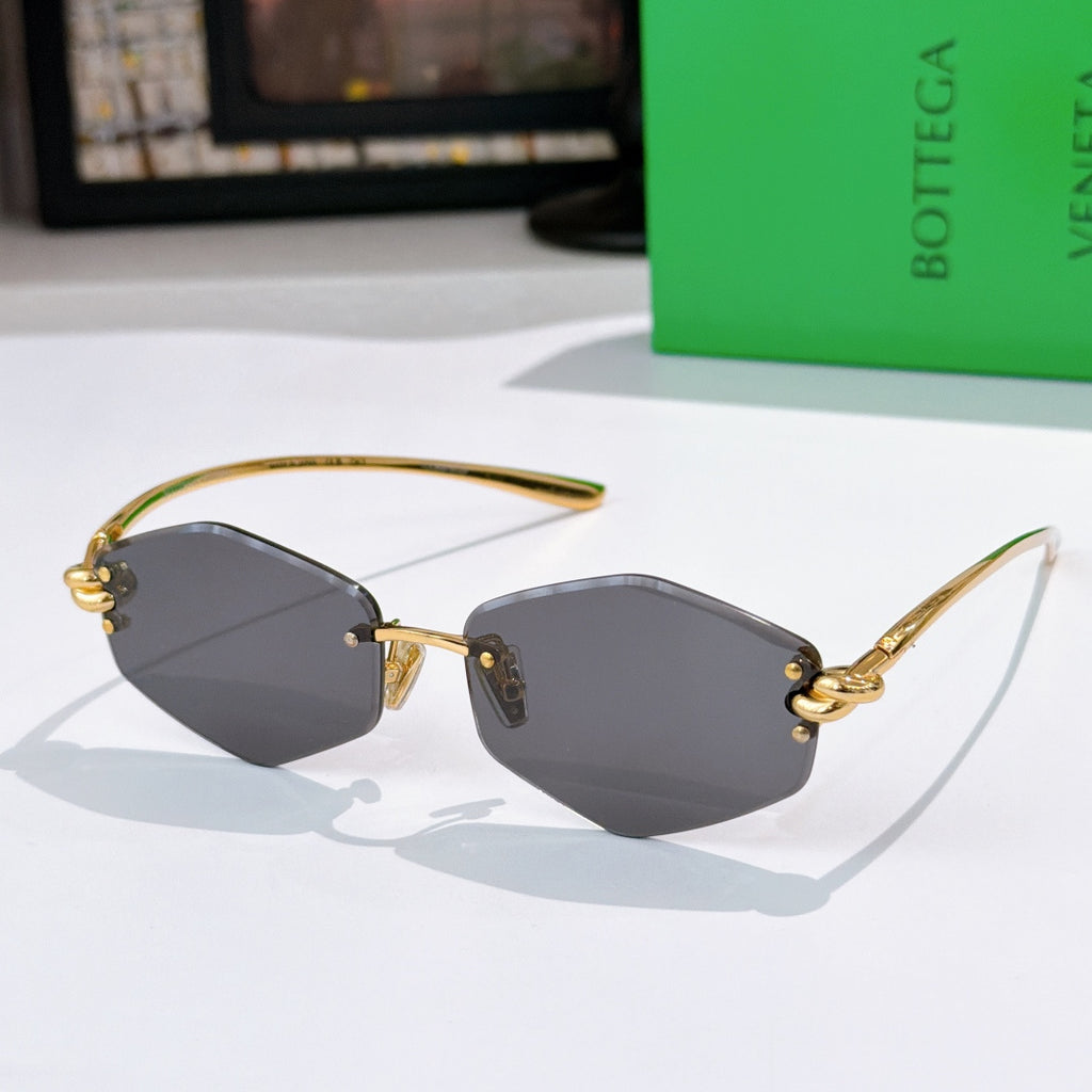Gold metal sunglasses with dark gray lenses and small side studs