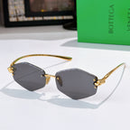 Gold metal sunglasses with dark gray lenses and small side studs